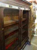 A vintage adjustable two-door bookcase (glass missing) together with a corner cupboard, rattan