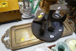 An Islamic decorated brass tray, two cobbler's lasts & a bake stone Condition Report: please