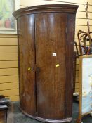 An antique bow front mahogany hanging corner cupboard Condition Report: please request* *Condition