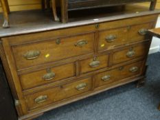 An antique oak coffer with a false drawer front & a two-drawer base with brass handles &