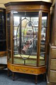 An attractive antique display cabinet in the manner of Edwards & Roberts with single centre oval
