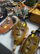 Three painted ethnic masks & a parcel of wooden ornaments ETC Condition Report: please request* *