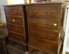 A pair of reproduction small chests of four drawers with swan neck handles Condition Report: