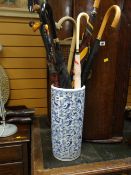 A blue & white pottery stick stand & contents Condition Report: please request* *Condition is not