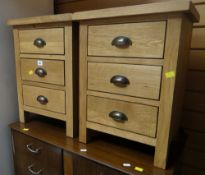 A pair of modern three-drawer oak bedside tables Condition Report: please request* *Condition is not