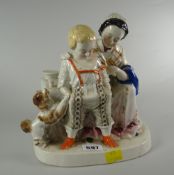 A Staffordshire pottery model of a mother, infant boy & spaniel at a table Condition Report: