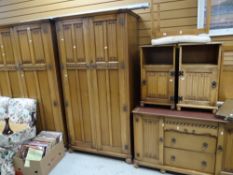 A suite of linen-fold bedroom furniture comprising two double wardrobes, pair of bedside tables,