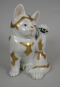 A Kutani-type porcelain lucky charm cat with paw raised Condition Report: please request via