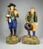 A pair of Whieldon type pottery figures of walking peasants wearing clogs on naturalistic bases,