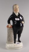 A nineteenth century Staffordshire figure of the preacher John Bryan standing beside a column with