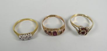 Three gold rings including three-stone diamond ring, garnet ring (one stone missing) Condition