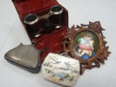 A cased set of leather bound opera glasses, a vintage silver purse, a vintage souvenir purse &
