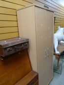 A modern wood effect two-door wardrobe, a vintage overnight case monogrammed EH Condition Report: