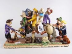A Widdecombe pottery model of many jolly figures, inscribed with Bill Bruer, Ian Stewer, Peter