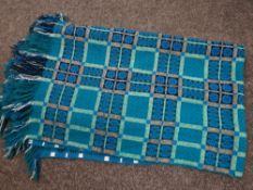A good Welsh blanket of traditional form with green / blue ground & geometric checker decoration