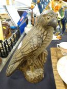 A pottery perched falcon Condition Report: please request via email. Condition reports not stated