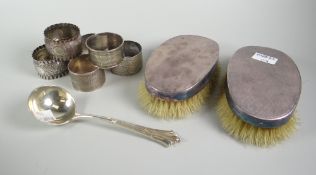 A pair of machine turned silver backed clothes brushes, six silver napkin rings ETC Condition