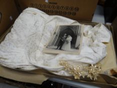 A boxed 1950s satin bodice wedding dress with beaded neckline, silk net veil, in original box (
