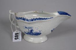 An eighteenth century English blue & white cream jug with moulded decoration & three landscape