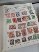 A vintage world stamp album, approximately 40% completed with world stamps Condition Report: