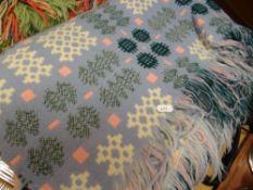 A Derw Mill Welsh blanket in pale blue ground and green, yellow & cream geometric decoration with