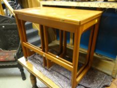 A mid-century G-Plan or McIntosh nest-of-three coffee tables, the parent table with foldover