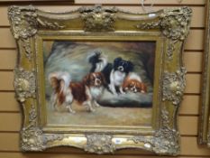 A reproduction oil on canvas in a fancy gilt frame of three King Charles spaniel dogs, signed S