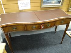 A good quality inlaid mahogany serpentine front sideboard of three drawers raised on tapered