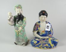 JAPANESE PORCELAIN STUDY OF A SEATED MEDITATING FEMALE in geometric & stylized blue robes,
