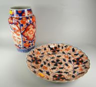 JAPANESE PORCELAIN RIBBED VASE IN IMARI PALETTE decorated with floral & foliate designs with