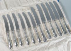 TWO SETS OF SIX KNIVES, one with silver handles (Sheffield) the other with white metal handles. (12)
