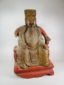 19th CENTURY CARVED PAINTED FIGURE OF A CHINESE OFFICIAL WITH RUYI SCEPTRE SEATED ON OPEN ELBOW