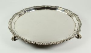 GEORGE V SILVER SALVER, having pie crust edge raised on three ball and claw feet. Sheffield 1919,