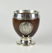 GEORGE V SILVER MOUNTED COCONUT SHELL GOBLET, raised on circular base with applied 1860 The National