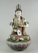 JAPANESE PORCELAIN FIGURE of a female seated with sword on lotus leaf base, possibly a seated