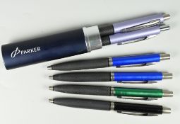 FOUR MODERN PARKER REFLEX BALLPOINT PENS one black, one green, two blue together with a metallic