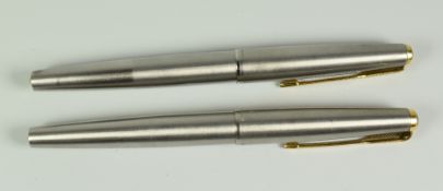 TWO VINTAGE STAINLESS STEEL PARKER 65 FLIGHTER DELUXE FOUNTAIN PENS 14ct gold nibs & gold trims