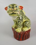 CHINESE PORCELAIN MODEL OF A TIGER in 17th century Kakiemon style on a rocky outcrop, 26cms high