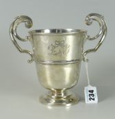 EDWARD VII SILVER PEDESTAL TROPHY CUP having twin scroll whiplash handles with engraved initials 