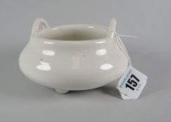 CHINESE TWIN-HANDLED POTTERY CENSER raised on three feet, in white glaze, unmarked, 13cms at