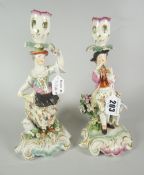 PAIR OF 19th CENTURY PORCELAIN FIGURAL CANDLESTICKS depicting male & female with flowers & animals