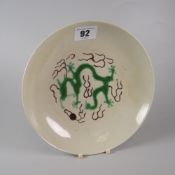 CHINESE PORCELAIN SHALLOW DISH RAISED ON CIRCULAR FOOT decorated with green five clawed dragon