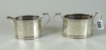 GEORGE V SILVER MATCHING TWIN HANDLED SUCRIER AND CREAM JUG of tetradecagon form with engraved