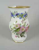 A FINE FRENCH PORCELAIN BELLIED VASE painted with a continuous trail of flowers and two large