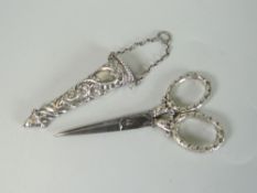 VICTORIAN PAIR OF SILVER AND STEEL SCISSORS in repousse decorated case. Birmingham 1889 by Levi &