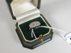 18CT WHITE GOLD DIAMOND CLUSTER RING made up of five central baguette diamonds and fourteen