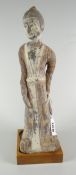 BELIEVED CHINESE TERRACOTTA FIGURE OF A FEMALE ATTENDANT on square section stand, 27.5cms high
