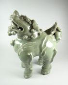 CHINESE CELADON GLAZE DOG OF FOO OR GUARDIAN LION the removable head revealing cavity, 29cms high