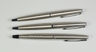 THREE STAINLESS STEEL PARKER 45 BALLPOINT PENS one early original Flighter with black plastic tail