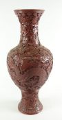 CHINESE CARVED CINNABAR LACQUER VASE depicting five claw dragon chasing flaming pearl amongst